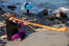 Surfer Seann Nichols receives unexpected sound healing from Darrell "Dearborn" Hicks as he performs sound healing using the digeridoo on the beach in Ventura, Calif., on Thursday, June 2, 2011. (Photo by Victoria Linssen / Brooks Institute ©2011)